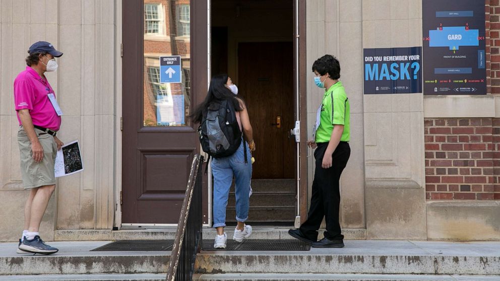 PHOTO: Safety ambassadors assist a UNC-Chapel Hill student into class at Gardner Hall at the University of North Carolina in Chapel Hill, N.C., Aug. 10, 2020.