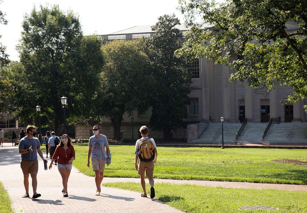 PHOTO: Students walk on campus during the first day of classes during the Coronavirus pandemic, at the University of North Carolina in Chapel Hill, N.C., Aug. 10, 2020.