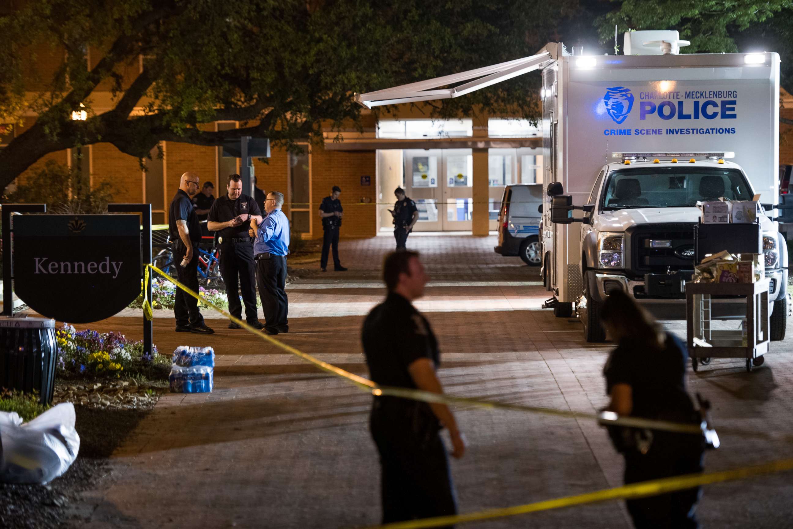 PHOTO: Charlotte-Mecklenburg crime scene investigators talk in front of the Kennedy building where a gunman killed two people and injured four students at UNC Charlotte, May 1, 2019, in Charlotte, North Carolina.