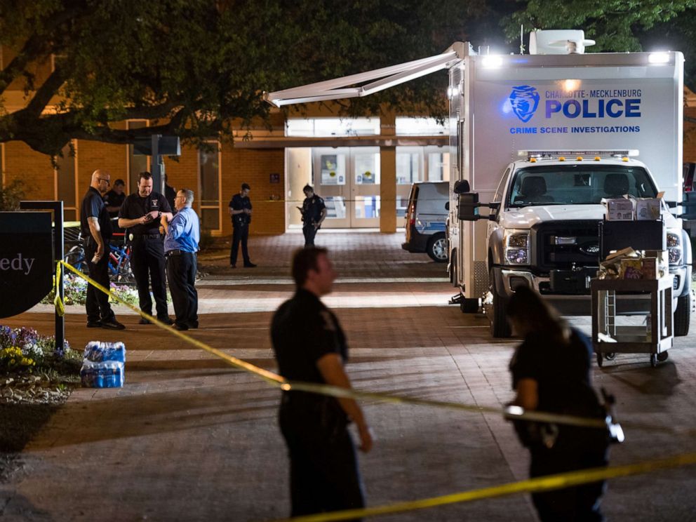 PHOTO: Charlotte-Mecklenburg crime scene investigators talk in front of the Kennedy building where a gunman killed two people and injured four students at UNC Charlotte, May 1, 2019, in Charlotte, North Carolina.