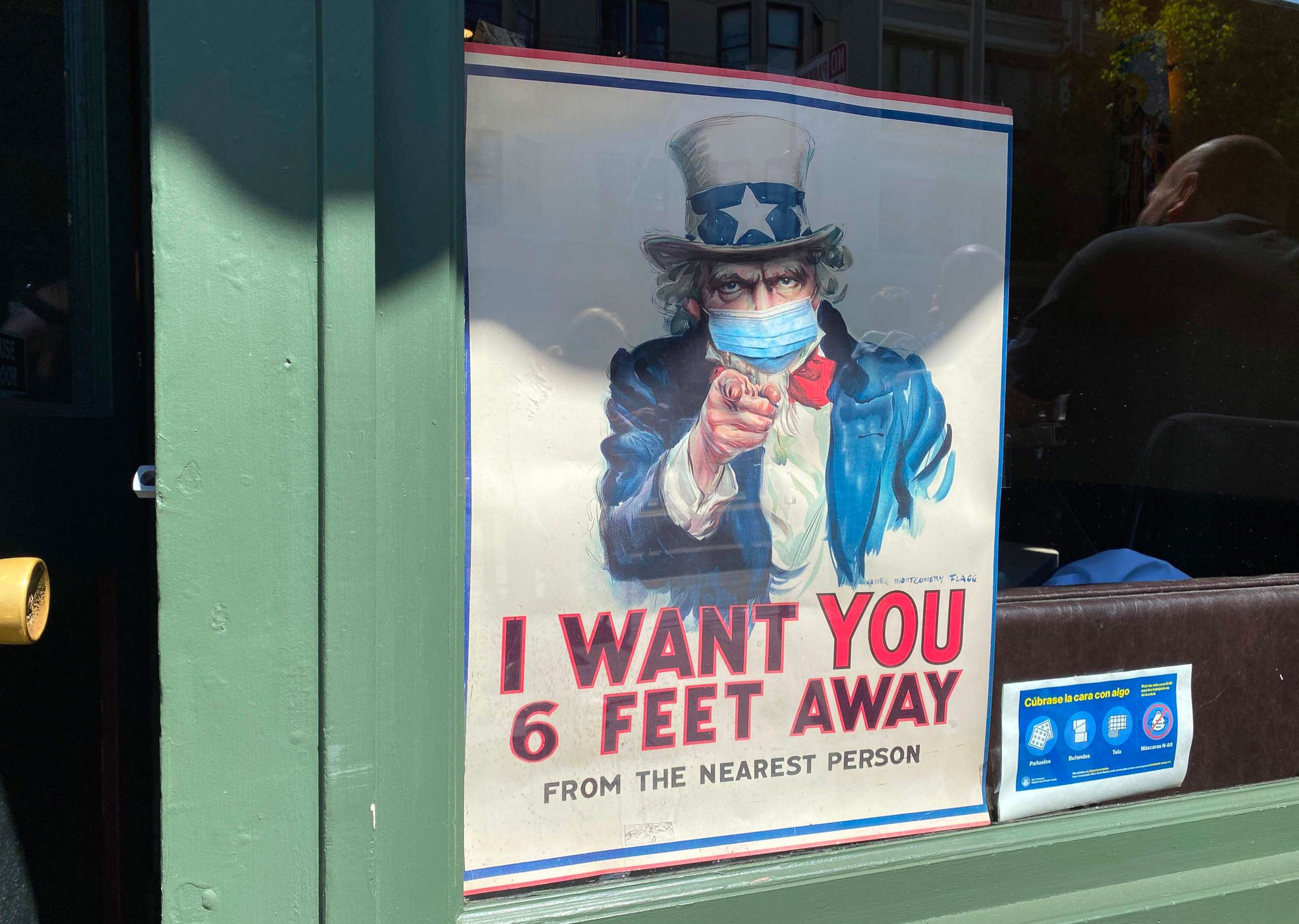 PHOTO: The iconic "I Want You for U.S. Army" Uncle Sam poster is seen wearing a mask and demanding people to stand six feet away in San Francisco, California, on July 31, 2020.