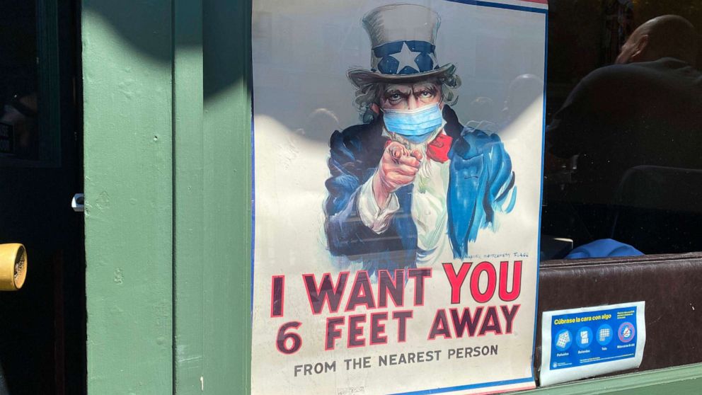 PHOTO: The iconic "I Want You for U.S. Army" Uncle Sam poster is seen wearing a mask and demanding people to stand six feet away in San Francisco, California, on July 31, 2020.