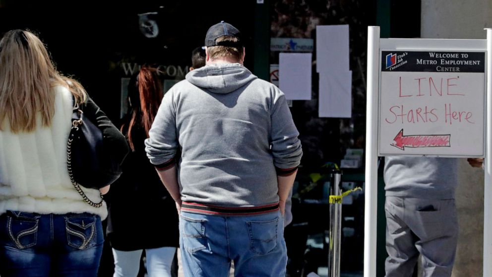 PHOTO: People line up outside the Utah Department of workforce Services, April 13, 2020, in Salt Lake City.