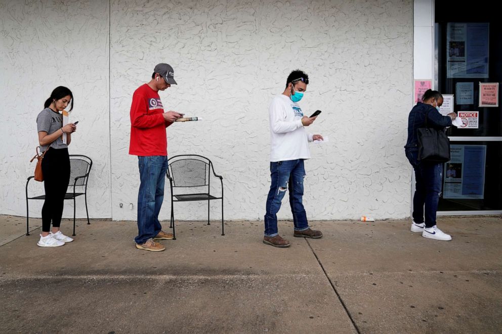 PHOTO: People who lost their jobs wait in line to file for unemployment following an outbreak of the coronavirus disease (COVID-19), at an Arkansas Workforce Center in Fayetteville, Arkansas, April 6, 2020.