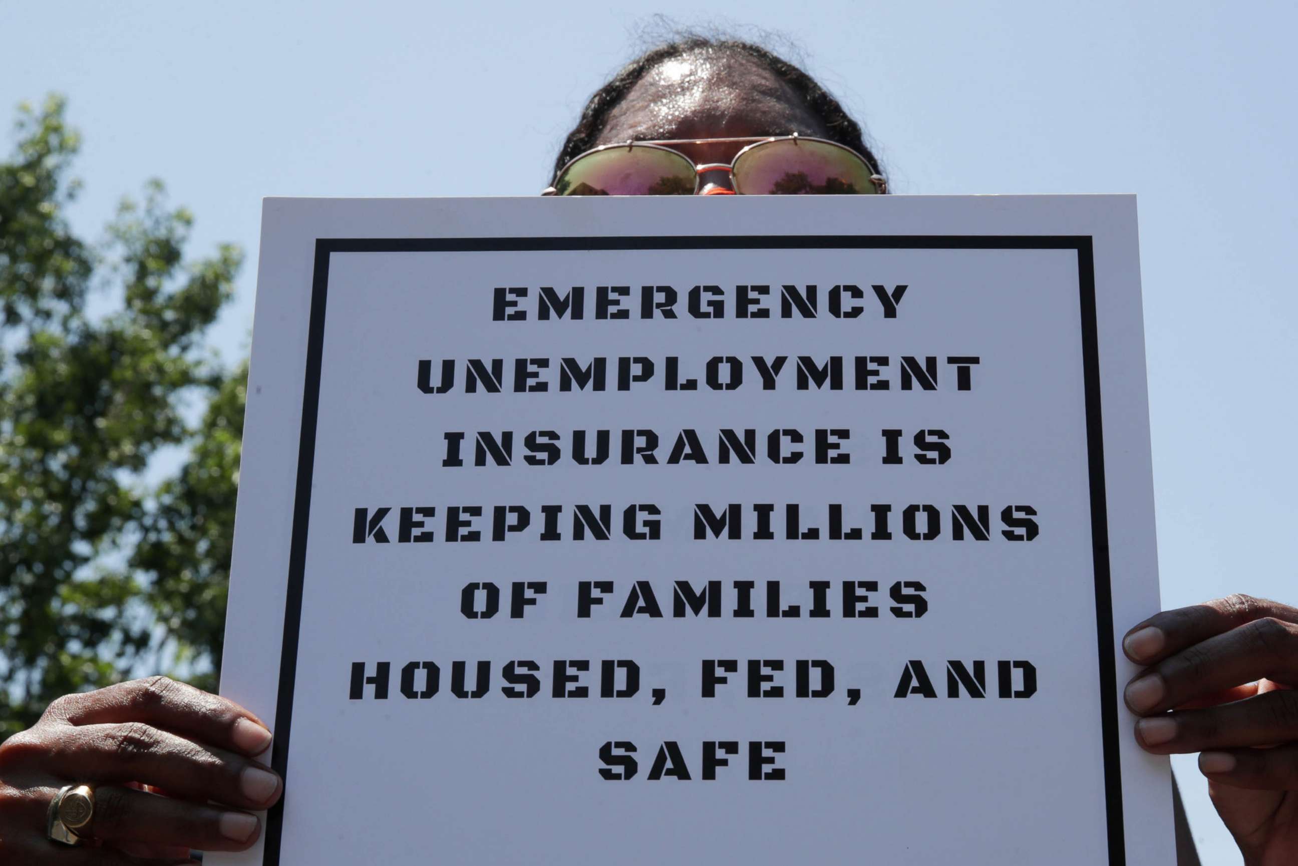 PHOTO: Protesters temporarily block the street to Senate Majority Leader Mitch McConnell's house with a live band on a flatbed truck, demanding the extension of coronavirus disease related unemployment aid, on Capitol Hill in Washington, July 22, 2020. 