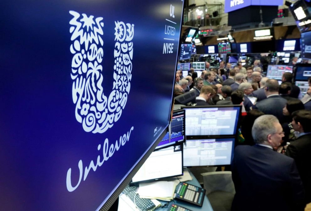 PHOTO: The logo for Unilever appears above a trading post on the floor of the New York Stock Exchange, March 15, 2018. Consumer products giant Unilever said they are pledging to halve its use of non-recycled plastics by 2025.