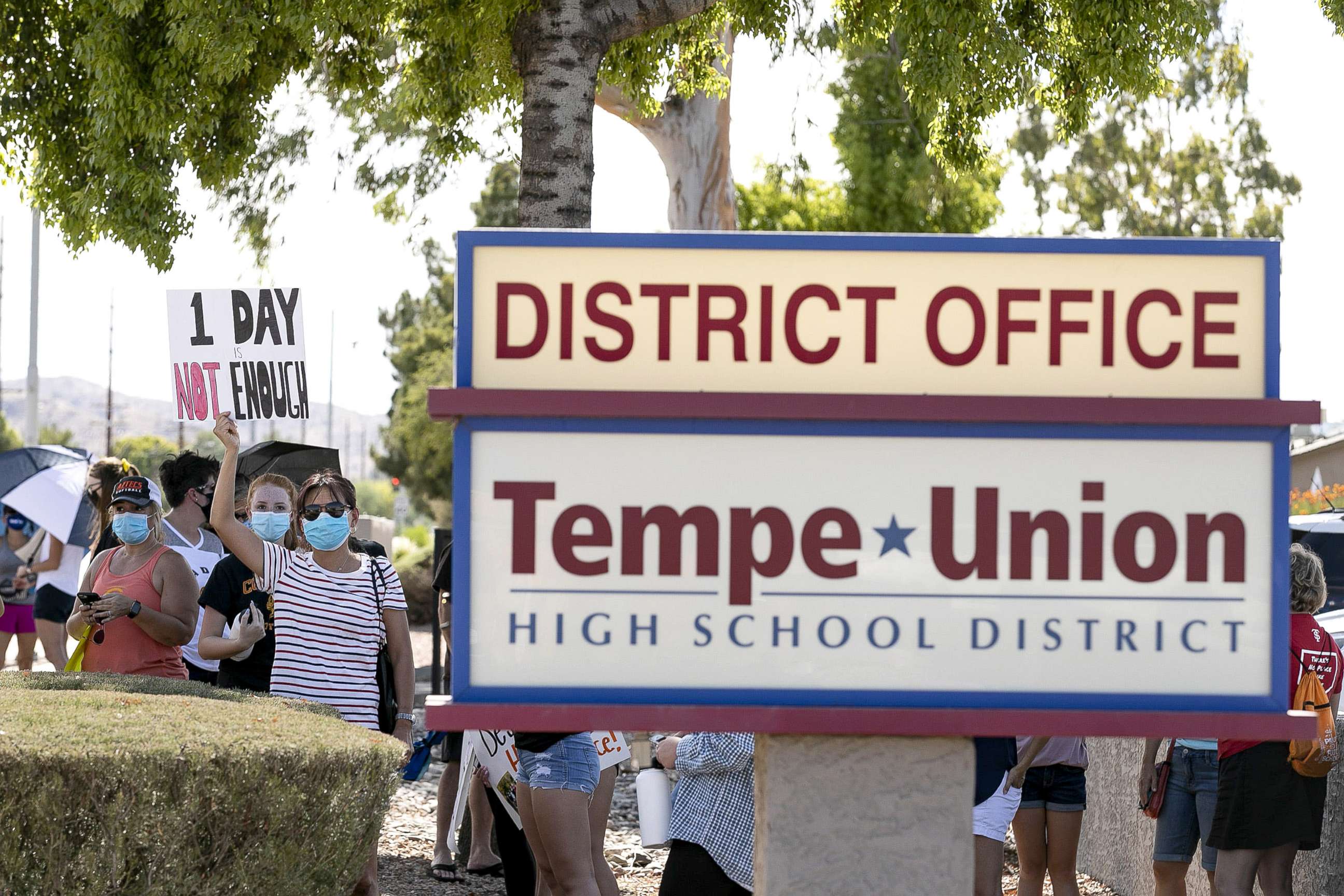 PHOTO: People gather for a rally in front of the Tempe Union High School District  office to protest the plan to go back to school with one in-person class a week in the fall in Tempe, Ariz., June 24, 2020.
