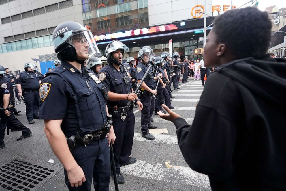 PHOTO: Police officers yell at people to move on the the sidewalk on Broadway as they try clear the crowd from the Union Square area, Aug. 4, 2023, in New York.