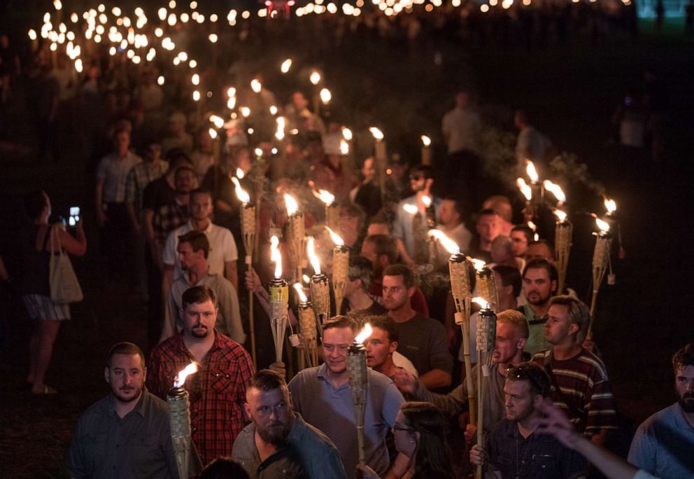 PHOTO: People march with white nationalists and white supremacists carrying torches in a "Unite the Right" rally that paraded through the University of Virginia campus in Charlottesville, Va., Aug. 11, 2017.