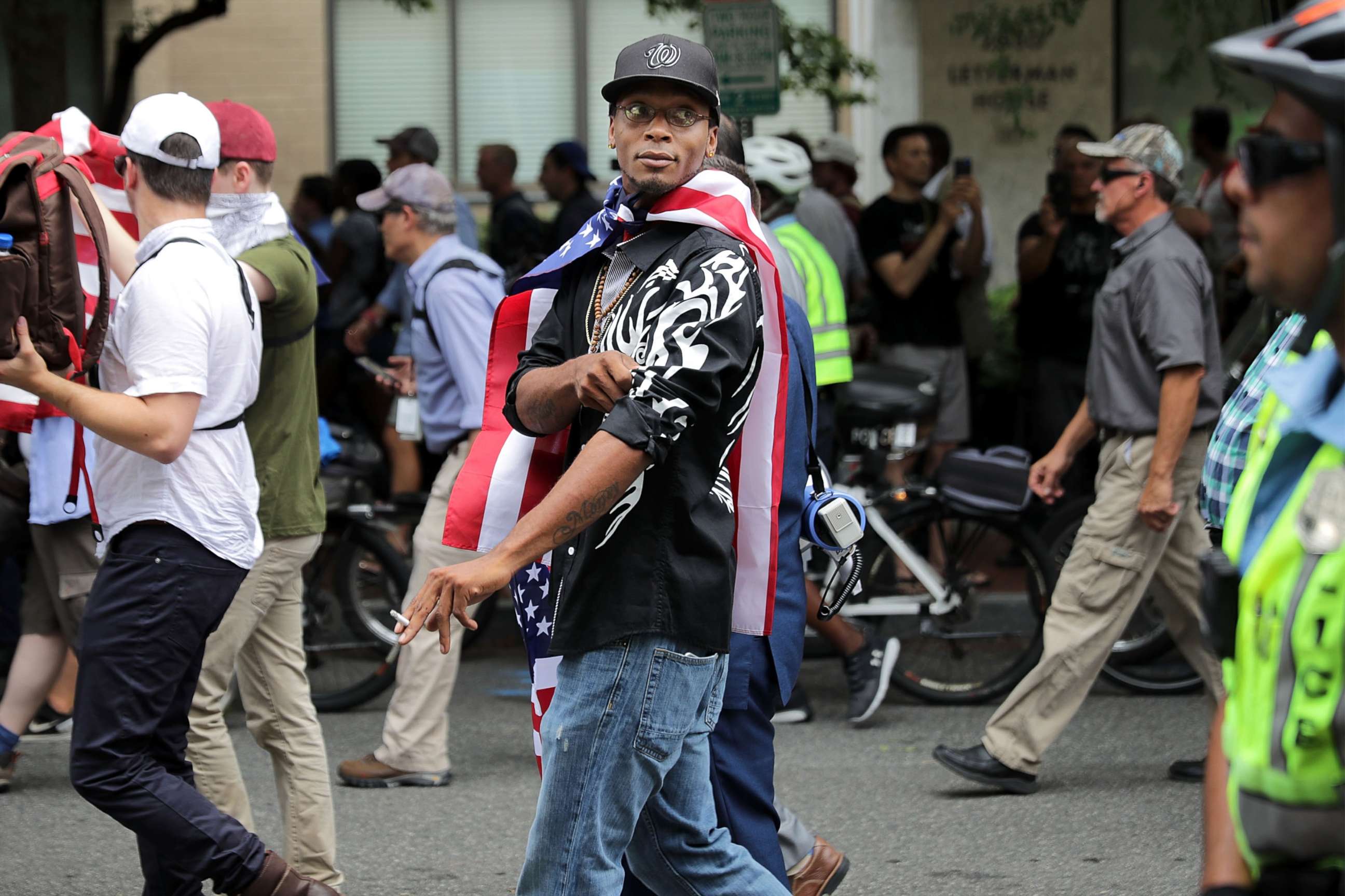 PHOTO: DC Metro Police form a protective phalanx around "Unite the Right" rally participants as they march to the White House, Aug. 12, 2018, in Washington, DC.