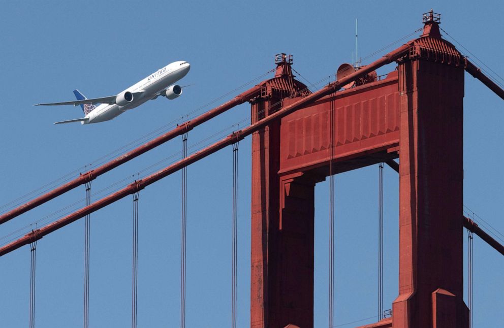PHOTO: A United Airlines Boeing 777-300ER flies over the Golden Gate Bridge during Fleet Week 2019 in San Francisco, Oct. 11, 2019.