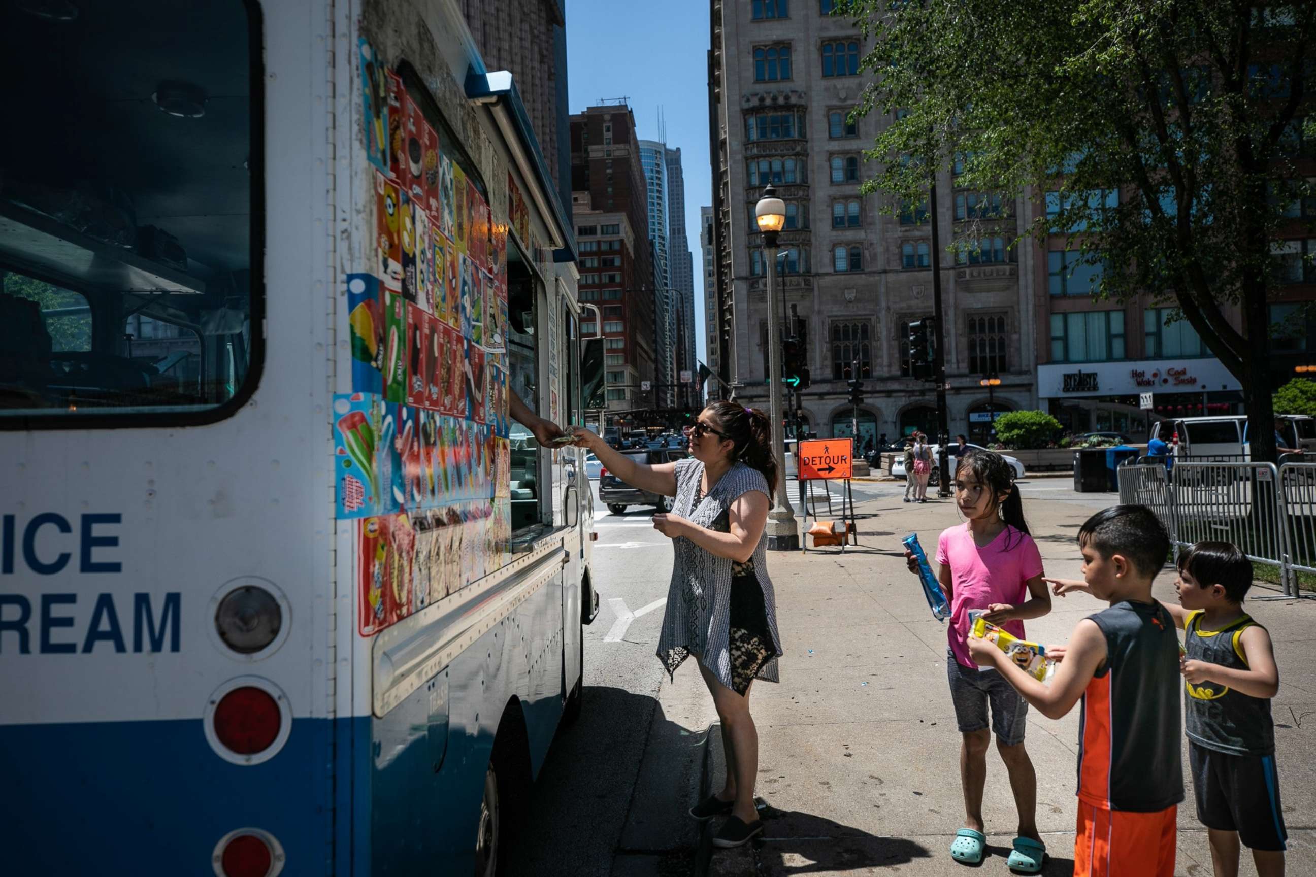 PHOTO: A woman buys ice cream in downtown Chicago, June 14, 2022.