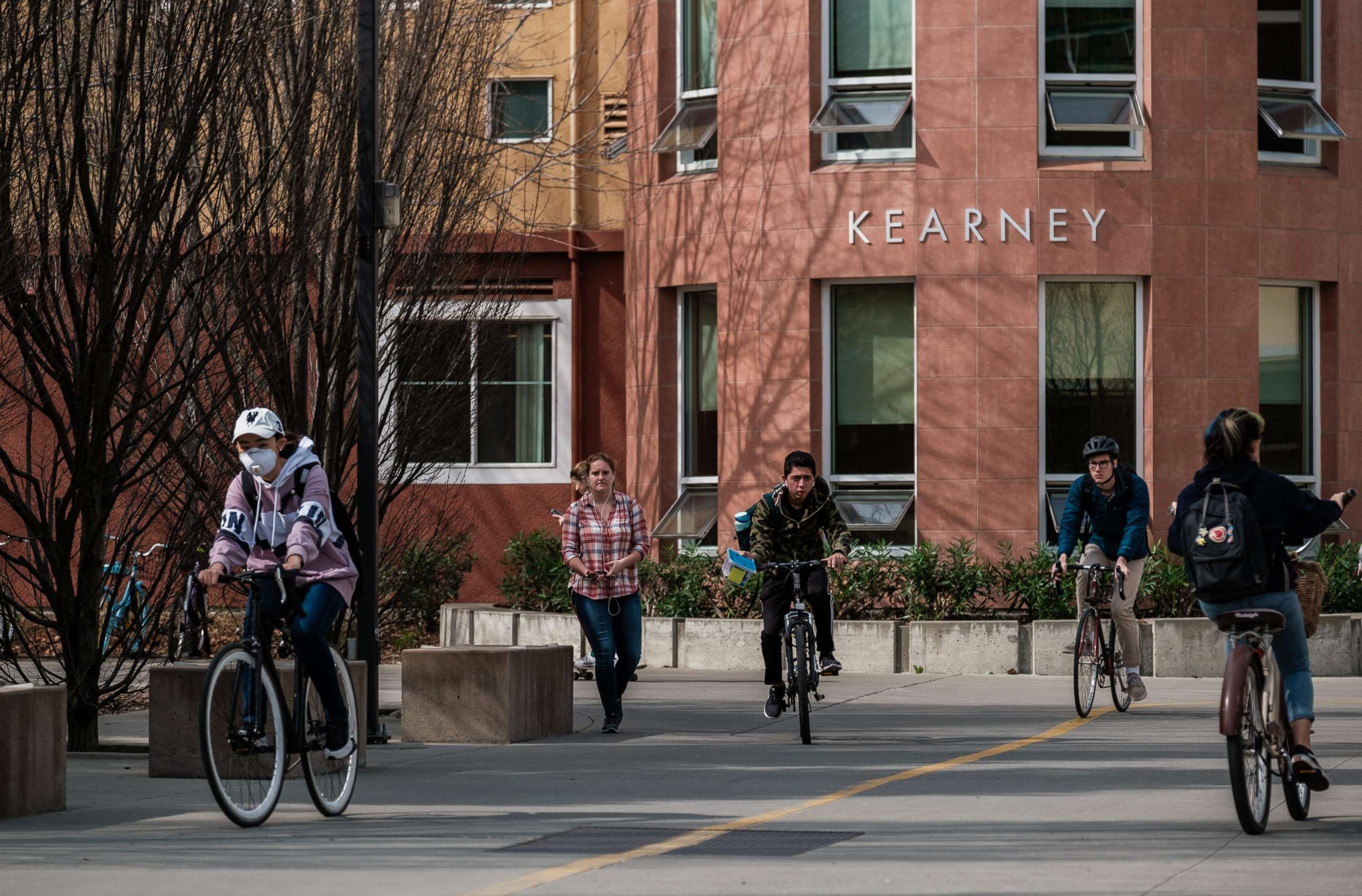 PHOTO: In this Feb. 28, 2020, file photo, students cycle past Kearney Hall on the campus of UC Davis where a student lived that has shown symptoms of COVID-19, in Davis, Calif.