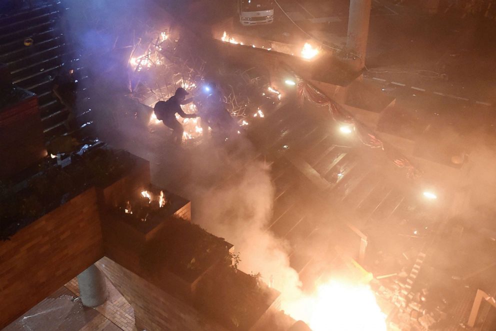 PHOTO: Anti-government protesters start a large fire in a staircase at the main entrance that leads into the Hong Kong Polytechnic University in the Hung Hom district of Hong Kong on Nov. 18, 2019.