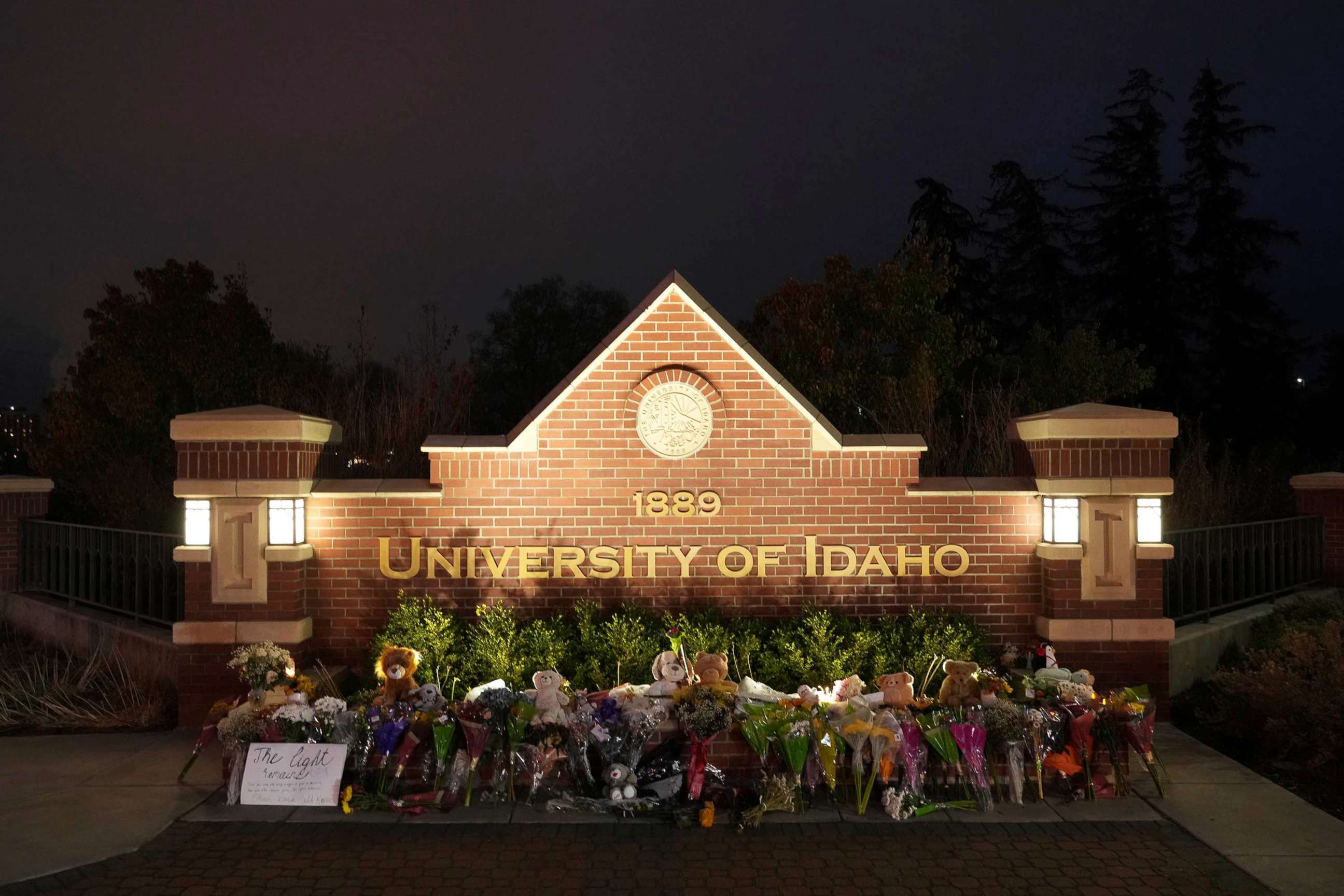 PHOTO: Flowers and other items are displayed at a growing memorial in front of a campus entrance sign for the University of Idaho, Wednesday, Nov. 16, 2022, in Moscow, Idaho.