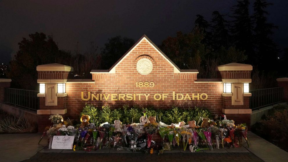 PHOTO: Flowers and other items are displayed at a growing monument in front of a University of Idaho campus entrance sign on Wednesday, November 16, 2022, in Moscow, Idaho.