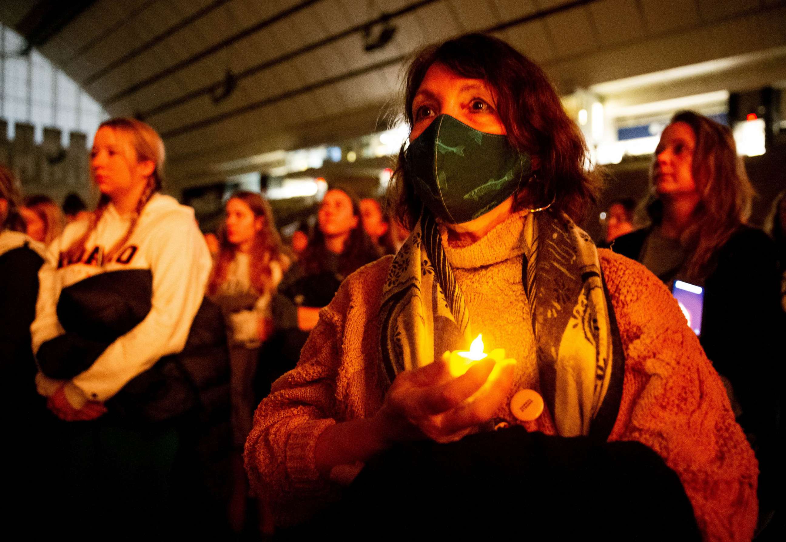 PHOTO: An attendee holds a battery-powered candle as the lights dim for a moment of silence for the victims during a vigil at the University of Idaho for four students found dead in their residence, Nov. 13 in Moscow, Idaho, Nov. 30, 2022.