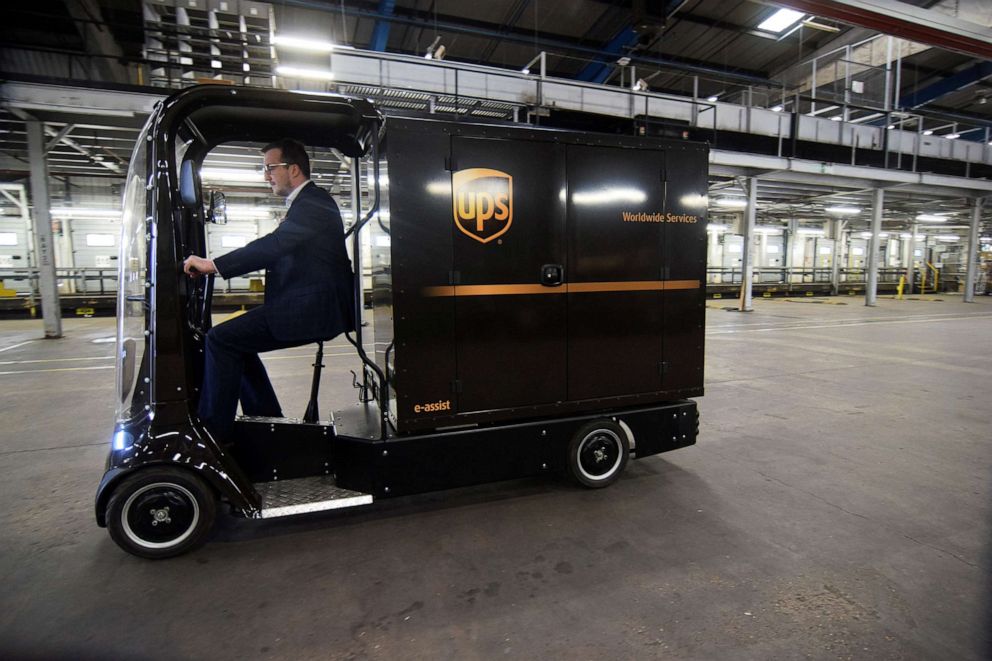 PHOTO: In this March 29, 2022, file photo, Luke Wake, UPS vice president of fleet maintenance and engineering, drives an "eQuad" electric bike that package delivery giant is testing for urban deliveries in a number of countries.