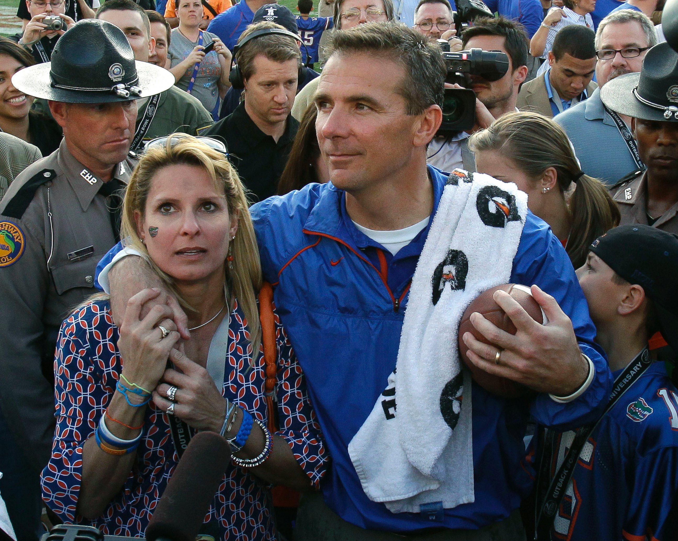 In this Jan. 1, 2011, file photo, then-Florida head coach Urban Meyer puts his arm around his wife Shelley after Florida defeated Penn State 37-24 in the Outback Bowl NCAA college football game, in Tampa, Fla.