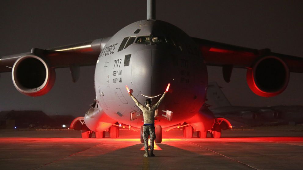 PHOTO: An airman guides a U.S. Air Force C-17 Globemaster after it returned from delivering cargo to Baghdad, Jan. 9, 2016 to a base in an undisclosed location in the Persian Gulf Region.