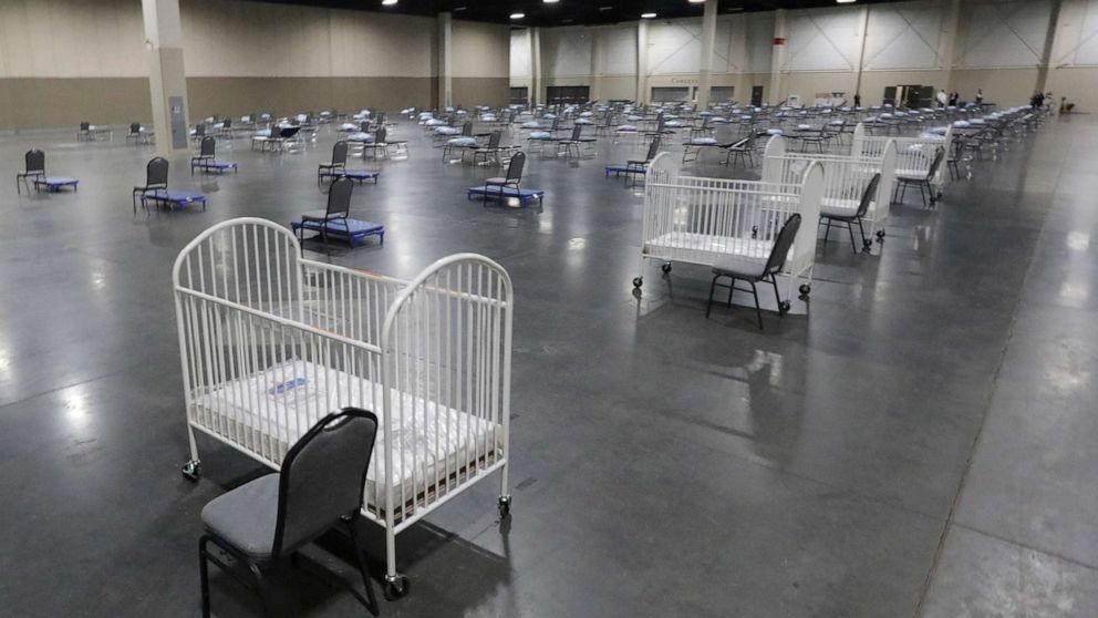 PHOTO: Cots and cribs are arranged at the Mountain America Exposition Center in Sandy, Utah, on April 6, 2020, as an alternate care site or for hospital overflow amid the coronavirus pandemic.