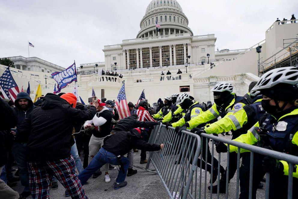 PHOTO: Supporters of then-U.S. President Donald Trump try to break through a police barrier during a riot at the United States Capitol in Washington, D.C., on Jan. 6, 2021.