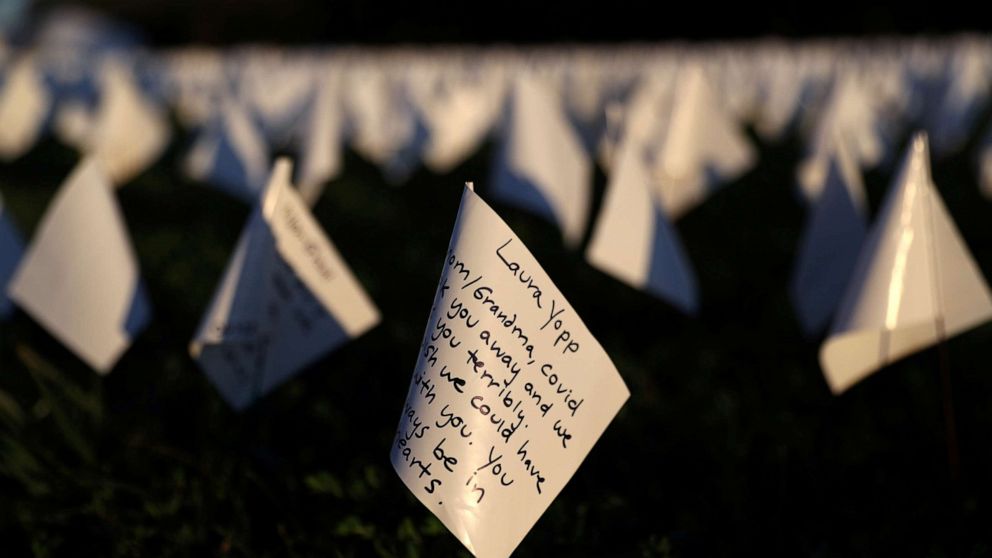 PHOTO: Notes to loved ones who died due to COVID-19, are written on white flags as part of a memorial for Americans as the national death toll reached 700,000, next to the Washington Monument in Washington, D.C., Oct. 1, 2021.