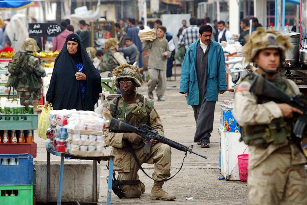 PHOTO: U.S. soldiers patrol a market in downtown Tikrit, Iraq, Dec. 16, 2003.