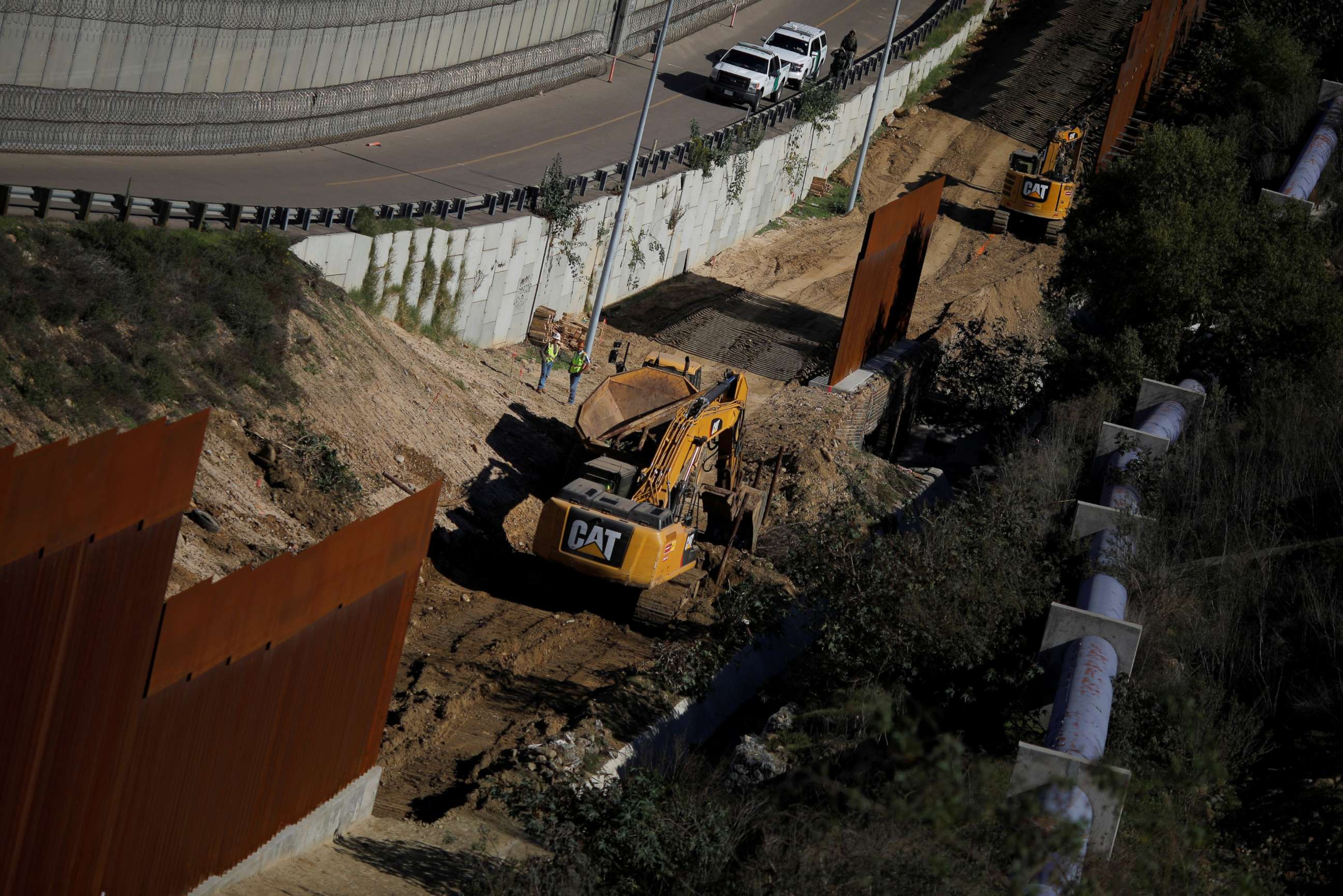 PHOTO: Workers are seen next a construction site of the border fence between United States and Mexico, seen from Tijuana, Mexico, Dec. 19, 2018.