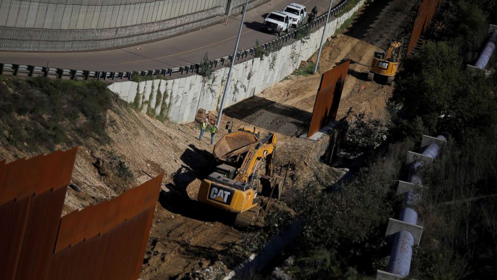PHOTO: Workers are seen next a construction site of the border fence between United States and Mexico, seen from Tijuana, Mexico, Dec. 19, 2018.