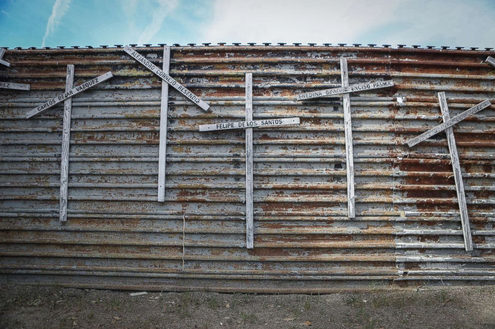 PHOTO: Crosses commemorating those who died attempting to cross the border into the United States line a section of the U.S.-Mexico border fence on April 6, 2018 in Tijuana, Mexico.