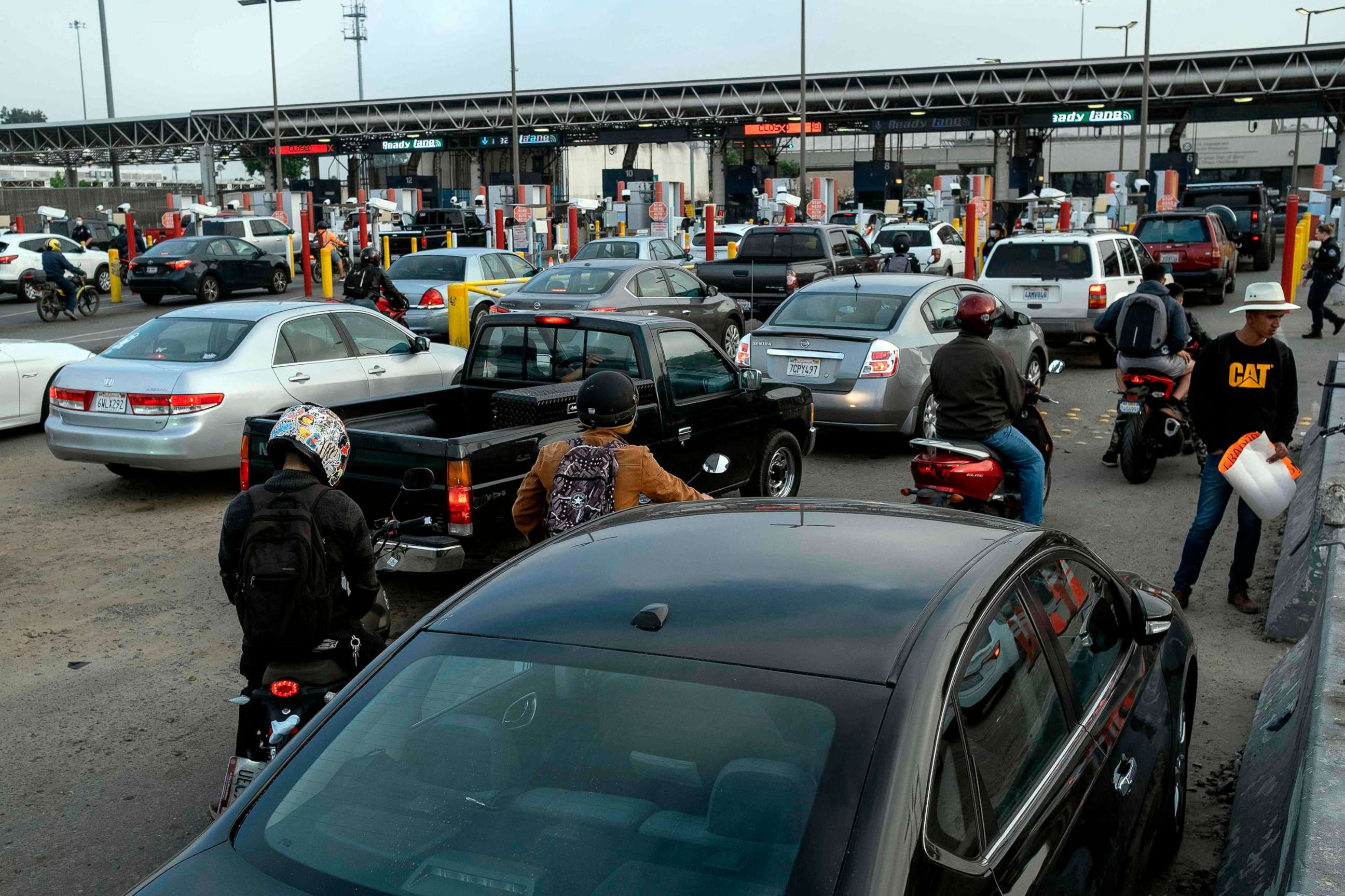 PHOTO: Commuters queue to cross Mexican border towards the US at the Otay commercial crossing port in Tijuana, Baja California state, Mexico, on July 7, 2020.