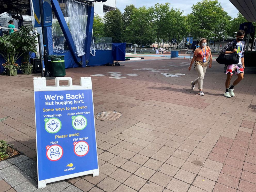 PHOTO: A sign reminding onlookers of proper health and safety protocols to prevent the spread of the coronavirus disease (COVID-19) is seen ahead of the start of the U.S. Open tennis Grand Slam tournament, in Queens, New York City, Aug. 29, 2020.