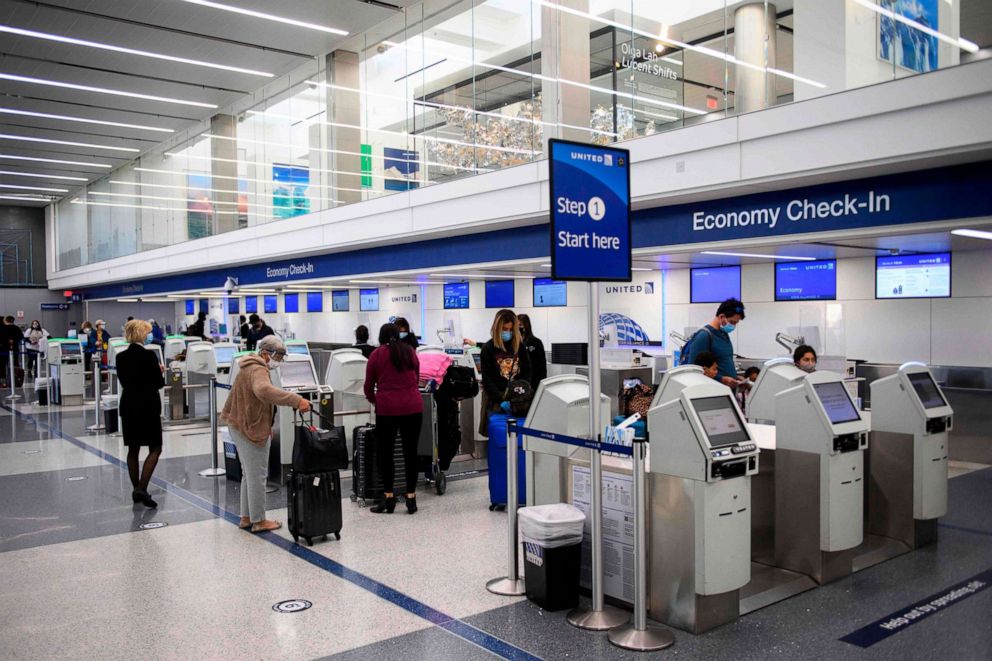 PHOTO: Passengers check-in for a United Airlines flight at Los Angeles International Airport ahead of the Thanksgiving holiday in Los Angeles, California, November 25, 2020. 