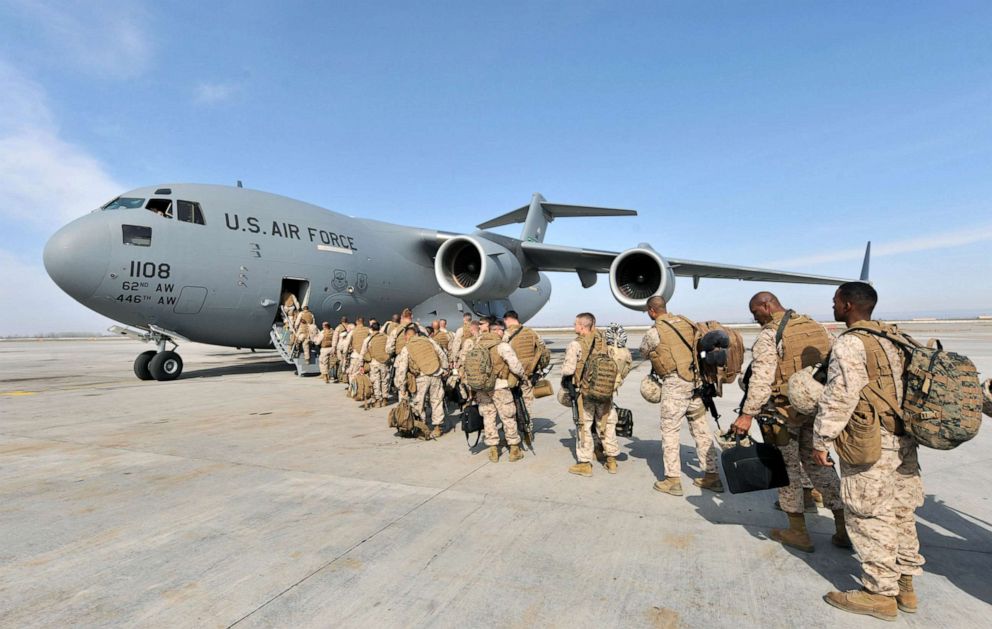 PHOTO: US Soldiers from the 1st Marine Expeditionary Force Pendleton camp bound for Helmand, Afghanistan board their flight at the Manas Transit Center, March 6, 2010. 