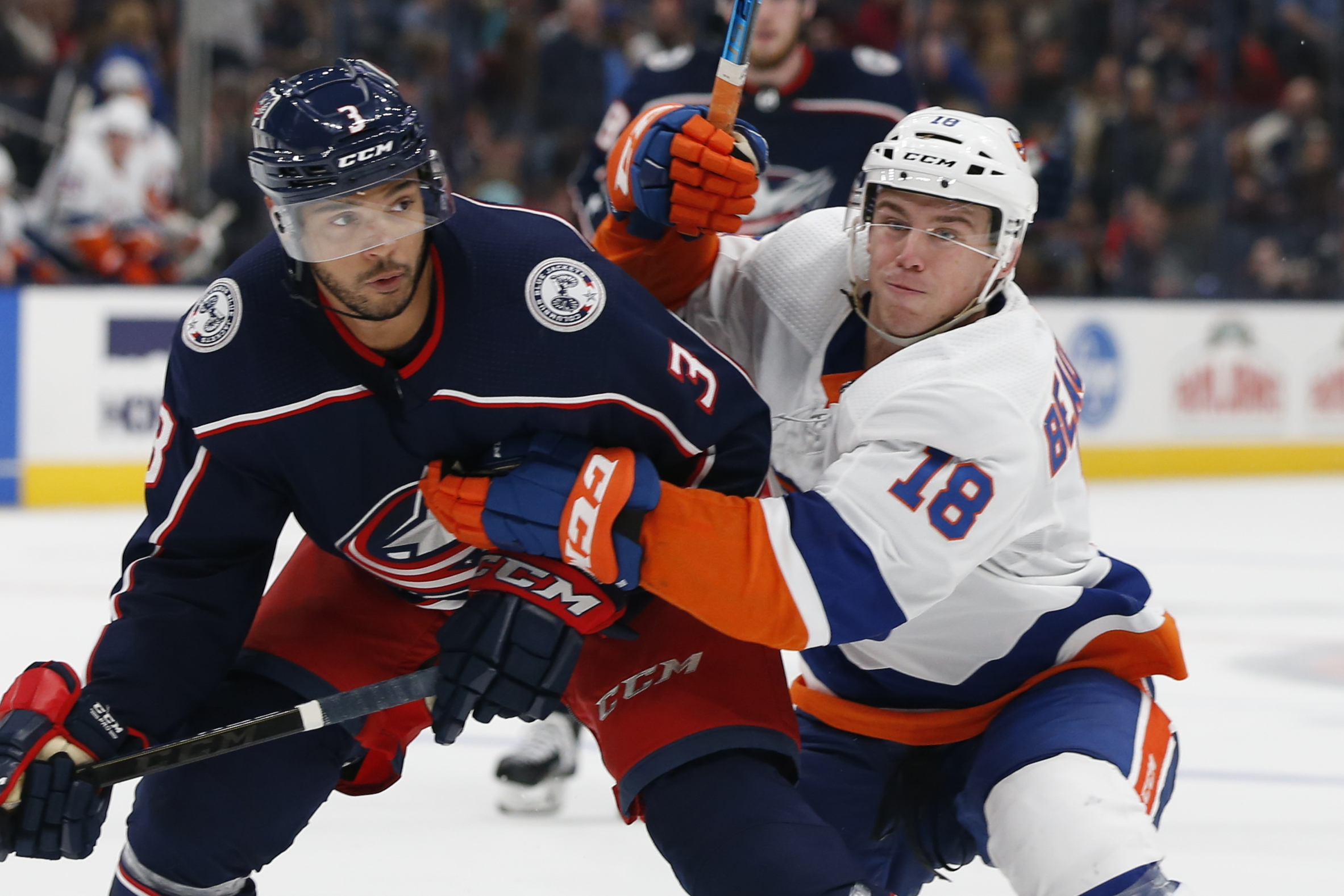 PHOTO: Columbus Blue Jackets' Seth Jones, left, and New York Islanders' Anthony Beauvillier chase a loose puck during the third period of an NHL hockey game Saturday, Oct. 19, 2019, in Columbus, Ohio. 