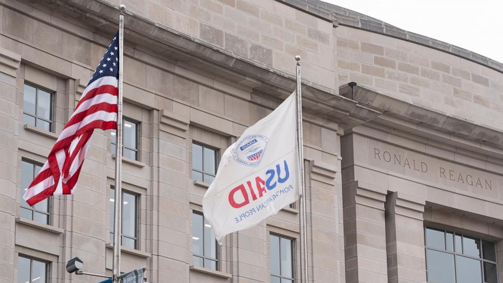PHOTO: The flag of the United States Agency for International Development, or USAID, right, flies alongside the American flag in front the USAID office in Washington, Feb. 3, 2025.