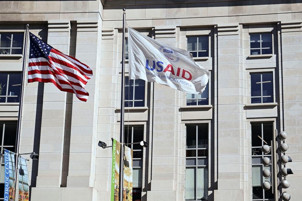 PHOTO: An American flag and USAID flag fly outside the USAID building in Washington, D.C., Feb. 1, 2025.