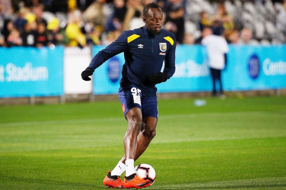 PHOTO: Usain Bolt warms up before a friendly trial match between the Central Coast Mariners and the Central Coast Select in Gosford, Australia, Aug. 31, 2018.