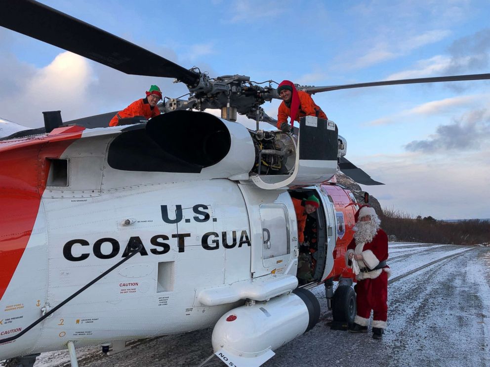 PHOTO: A Coast Guard Air Station Kodiak MH-60 Jayhawk helicopter aircrew delivers Santa, his elves and gifts to the children of various remote villages in Alaska, Dec. 12, 2018.
