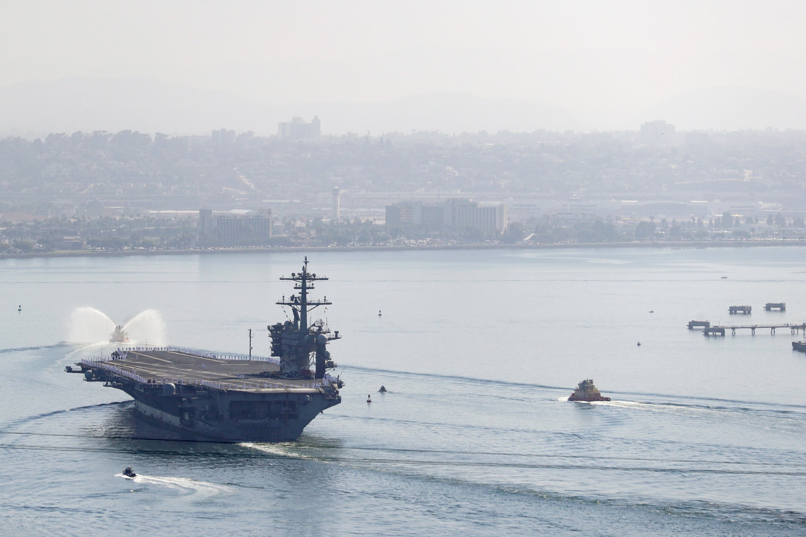 PHOTO: The USS Theodore Roosevelt aircraft carrier makes its way into San Diego Bay Thursday, July 9, 2020, seen from San Diego.
