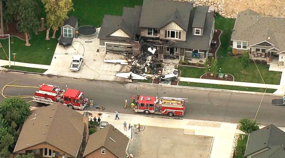 PHOTO: In this frame from video, emergency personnel work at the scene of a small plane that crashed into a house in Payson, Utah, Aug 13, 2018.