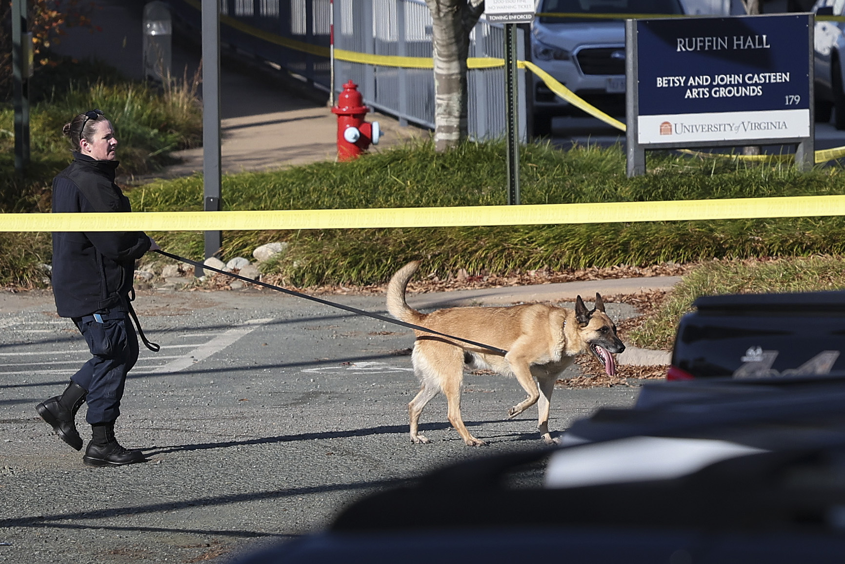 PHOTO: A law enforcement K9 team works the crime scene where 3 people were killed and 2 others wounded on the grounds of the University of Virginia, Nov. 14, 2022 in Charlottesville, Virginia.