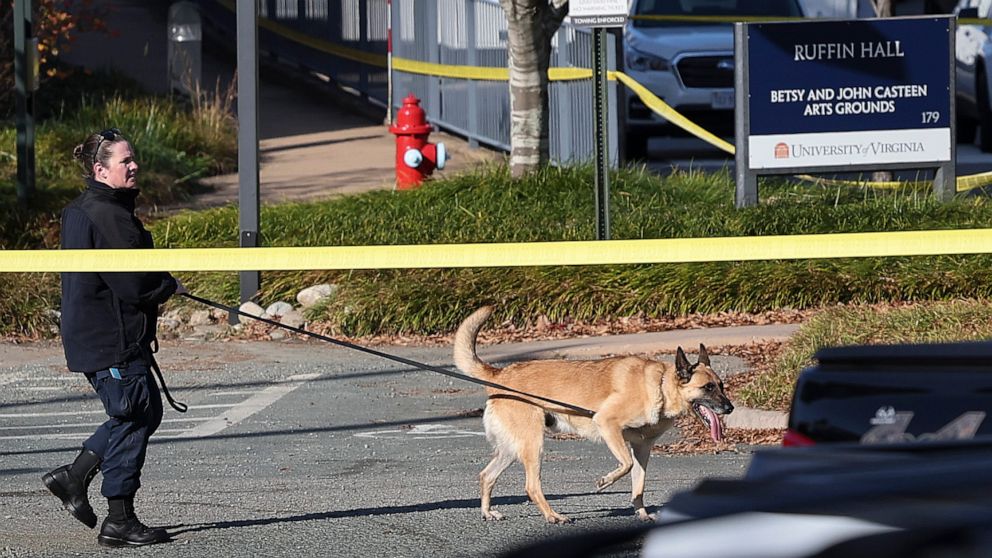 PHOTO: A law enforcement K9 team works the crime scene where 3 people were killed and 2 others wounded on the grounds of the University of Virginia, Nov. 14, 2022 in Charlottesville, Virginia.