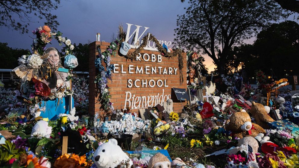 PHOTO: The sun sets behind the memorial for the victims of the massacre at Robb Elementary School, 24, 2022, in Uvalde, Texas.