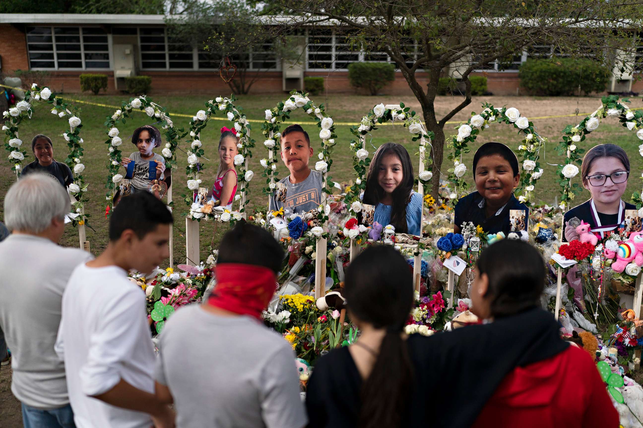 PHOTO: People gather at a memorial at Robb Elementary School in Uvalde, May 30, 2022, to pay their respects to the victims killed in last week's school shooting.