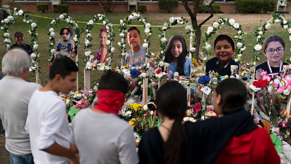 PHOTO: People gather at a memorial at Robb Elementary School in Uvalde, May 30, 2022, to pay their respects to the victims killed in last week's school shooting.