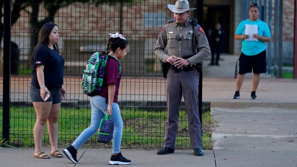 PHOTO: Students arrive at Uvalde Elementary, now protected by a fence and Texas State Troopers, for the first day of school, on Sept. 6, 2022, in Uvalde, Texas.