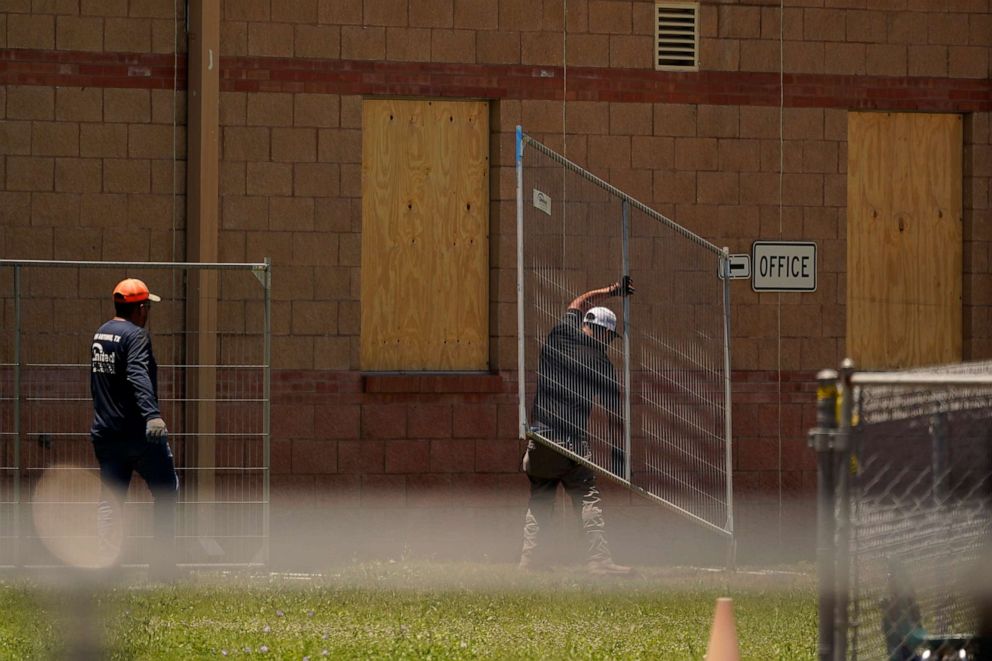 PHOTO: Workers place additional fencing around Robb Elementary School, the scene of a recent school shooting, Friday, June 3, 2022, in Uvalde, Texas.