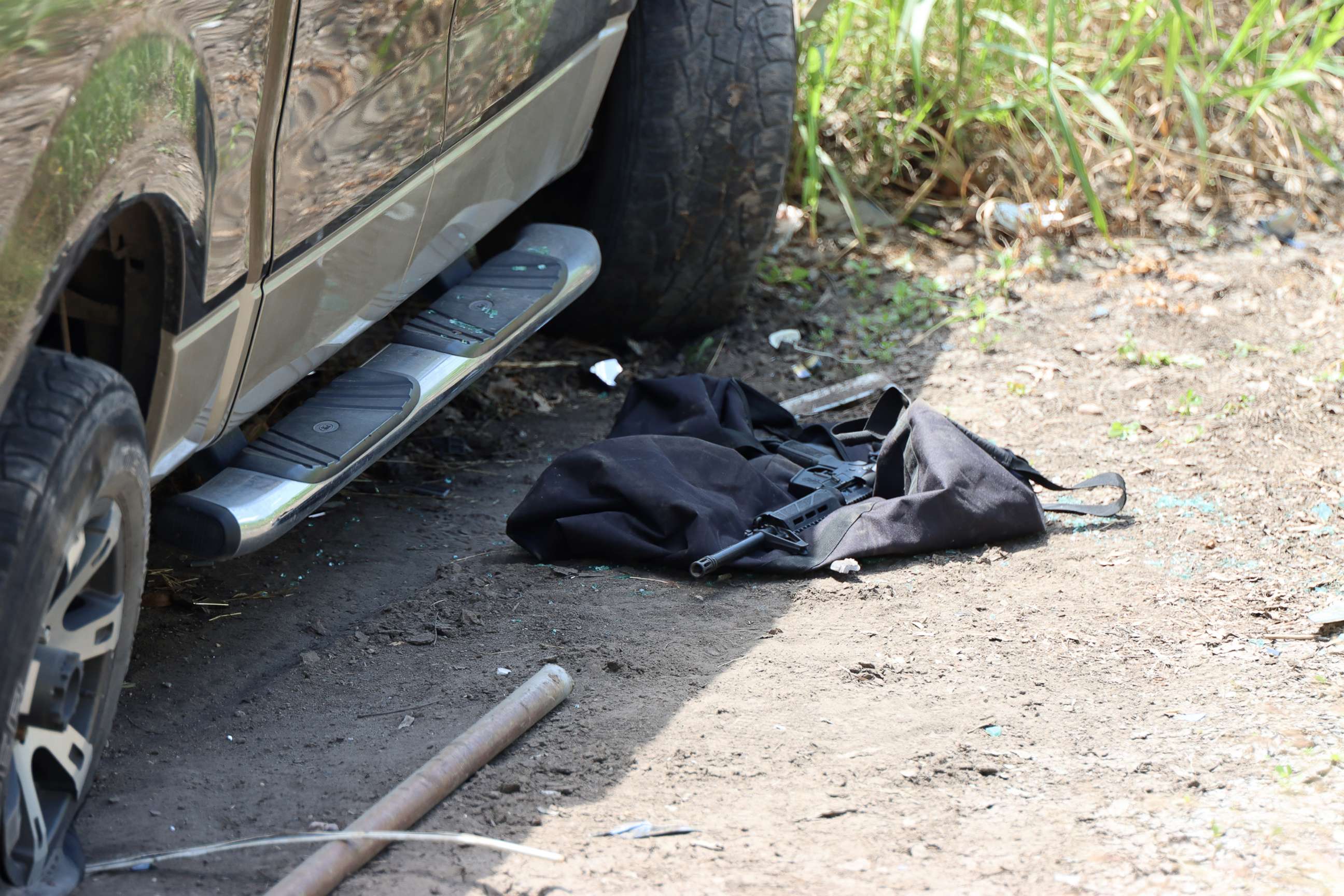 PHOTO: A gun lies on the ground next to the vehicle the suspect crashed near Robb Elementary School, May 24, 2022, in Uvalde, Texas.